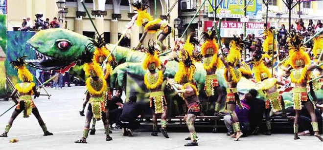ATI TRIBE warriors battle a giant reptile in a performance during Iloilo’s Dinagyang Festival on Sunday  NESTOR P. BURGOS JR./INQUIRER VISAYAS