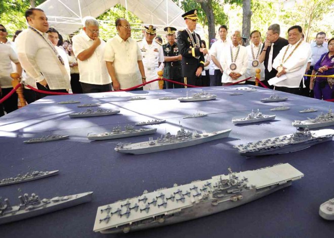 A collection of ship replicas is turned over to defense and Pangasinan officials led by Defense Secretary Voltaire Gazmin (fourth from right) and Gov. Amado Espino Jr. (right). WILLIE LOMIBAO/CONTRIBUTOR 