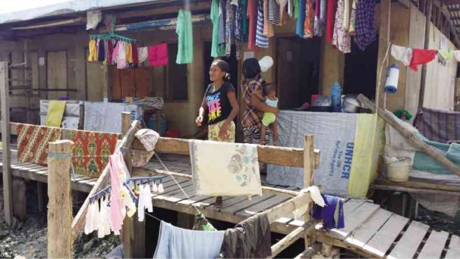 A BADJAO woman at the Masepla Transitory Site, where evacuees in bunkhouses are without electricity and with barely any potable water. JULIE S. ALIPALA/INQUIRER MINDANAO