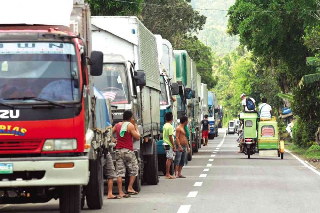 A QUEUE of cargo trucks stretches as long as 3 kilometers in Matnog after authorities gave priority to pilgrims headed for Tacloban City at the town port. MARC ALVIC ESPLANA/INQUIRER SOUTHERN LUZON
