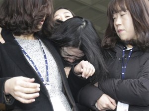 File photo of Cho Hyun-ah, center, former vice president of Korean Air Lines, as she is escorted by court officials as she leaves for Seoul Western District Prosecutors Office in December last year in connection with the nut rage case. AP 