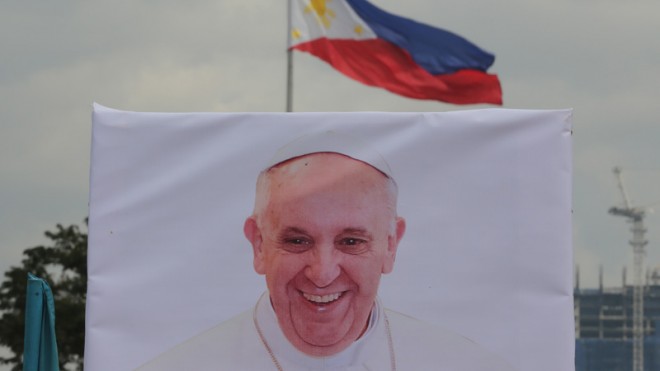 A photo of Pope Francis stands in front of a Philippine national flag as preparations for his visit continue at Manila's Rizal park, Philippines, Sunday, Jan. 11, 2015. Pope Francis embarks on his second Asian pilgrimage next week, visiting Sri Lanka and the Philippines exactly 20 years after St. John Paul II's record-making visit to two countries with wildly disparate Catholic populations. Francis will make headlines of his own, drawing millions of faithful in the Philippines and treading unchartered political waters following Sri Lanka's remarkable electoral upset this week. AP