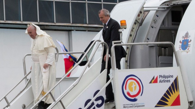 Pope Francis, followed by Alberto Gasbarri, Pope's trip organizer, arrives in Manila, Philippines, Saturday, Jan. 17, 2015. Francis traveled to the far eastern Philippines to comfort survivors of devastating Typhoon Haiyan in 2013 on Saturday, but cut his own trip short because of another approaching storm. (AP Photo/Alessandra Tarantino)