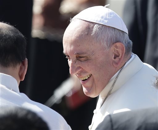 Pope Francis smiles as he chats with Philippine President Benigno Aquino III to board his Philippine Airlines chartered plane following a pastoral visit to Manila and typhoon-ravaged Tacloban city Monday, Jan. 19, 2015. AP