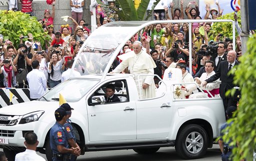 Pope Francis arrives at the Cathedral Basilica of the Immaculate Conception in Manila, Philippines, Friday, Jan. 16, 2015 while thousands of Filipinos welcome him with excitement. Pope Francis celebrated the holy mass with bishops, priests, nuns, and seminarians as part of his Apostolic Mission to the Philippines. (AP Photo/Ron Soliman)