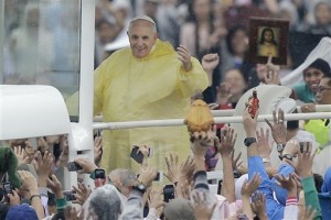 Pope Francis waves at the faithful as he arrives at Rizal Park to celebrate his final Mass in Manila, Philippines, Sunday, Jan. 18, 2015. Millions filled Manila's main park and surrounding areas for Pope Francis' final Mass in the Philippines on Sunday, braving a steady rain to hear the pontiff's message of hope and consolation for the Southeast Asian country's most downtrodden and destitute. (AP Photo/Bullit Marquez)