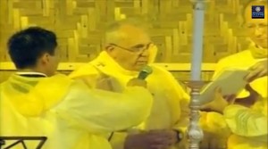 Pope Francis wears a yellow raincoat as he celebrates the mass in storm-ravaged in Leyte. Screengrab from RTV 