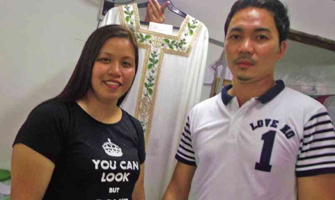RONALD Allan and Maricel Babaran, owners of Disenio Sagrado in Bulacan, are proud that Pope Francis will wear a vestment made by their shop. They allowed the Inquirer to see one of the vestment designs (background) but requested that the others not be photographed for they wanted the Pope and other church officials to see them first.  CARMELA REYES-ESTROPE 