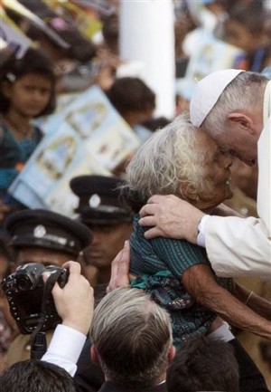 In this Wednesday, Jan. 14, 2015, file photo, Pope Francis greets a elderly woman as he arrives in Madhu, Sri Lanka. Pope Francis has worked to avoid cloaking himself in the mystical power that popes are so often endowed with by believers, but still many of the thousands who came out to see him hoped for a touch or a blessing from him.(AP Photo/Alessandra Tarantino, Pool, File)