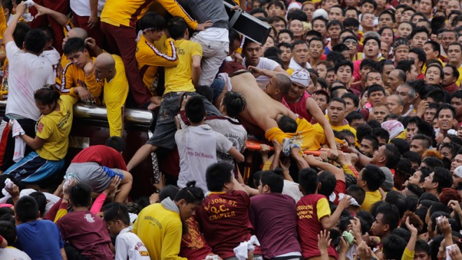 An unconscious devotee is loaded into a stretcher during a raucous procession to celebrate the feast day of the Black Nazarene Friday, January 9 in Manila. AP