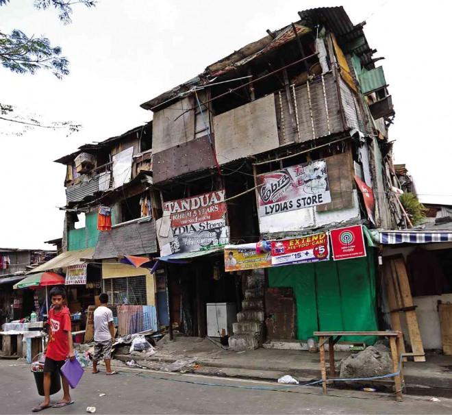 THE 36-UNIT ‘apartment’ on NIA Road before it was reduced to a giant heap (photo below)  on Friday     Photos by Raffy Lerma 
