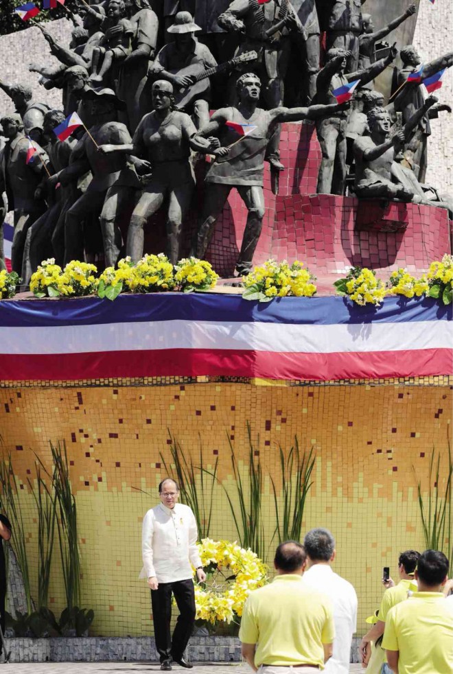 HEROES ABOVE ALL Dwarfed by a sculpture of heroes linking arms to defend freedom, President Benigno Aquino III leads the wreath-laying ceremony at the People Power Monument during the 29th anniversary of the Edsa People Power Revolution on Wednesday. The bloodless revolt saw people massing at Edsa in Quezon City, to protect soldiers and officials who had withdrawn their support from authoritarian President Ferdinand Marcos. GRIG C. MONTEGRANDE