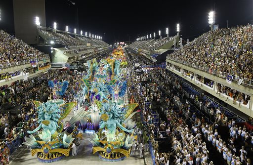 Performers from the Uniao da Ilha samba school parade during carnival celebrations at the Sambadrome in Rio de Janeiro, Brazil, Tuesday, Feb. 17, 2015. A German tourist died from stab wounds after resisting assailants who tried to rob him as the Rio carnival wound down, police told AFP Wednesday.  AP PHOTO/LEO CORREA 