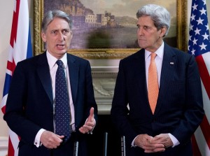US Secretary of State John Kerry looks on during a press conference with Britain's Foreign Secretary Philip Hammond, left,  in central London Saturday Feb. 21, 2015. US Secretary of State John Kerry, in London for talks with Foreign Secretary Philip Hammond, said Russia's conduct was "simply unacceptable" and that he expected to see agreement on further international sanctions in the coming days. "Russia has engaged in an absolutely brazen and cynical process over these last days. We know to a certainty what Russia has been providing to the separatists, how Russia is involved with the separatists," he told reporters.(AP Photo/ Laura Lean/Pool)