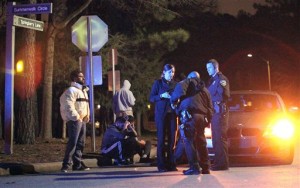 In this Tuesday, Feb. 10, 2015 photo, Chapel Hill police officers investigate the scene of three murders near Summerwalk Circle in Chapel Hill, N.C. A man, his wife and her sister, all college students, were shot to death at a quiet condominium complex near the University of North Carolina, but police had not yet given a motive or released details about the suspect. AP