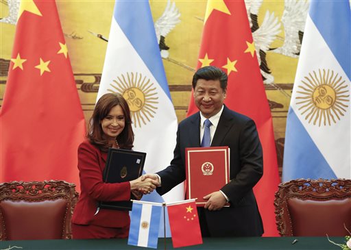Chinese President Xi Jinping, right, and Argentinian President Cristina Fernandez shake hands after signing documents following their meeting at the Great Hall of the People in Beijing Wednesday, Feb. 4, 2015. AP