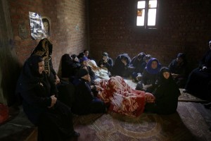 Women mourn over Egyptian Coptic Christians who were captured in Libya and killed by militants affiliated with the Islamic State group, outside of the Virgin Mary church in the village of el-Aour, near Minya, 220 kilometers (135 miles) south of Cairo, Egypt, Monday, Feb. 16, 2015. Egyptian warplanes struck Islamic State targets in Libya on Monday in swift retribution for the extremists' beheading of a group of Egyptian Christian hostages on a beach, shown in a grisly online video released hours earlier. (AP Photo/Hassan Ammar)