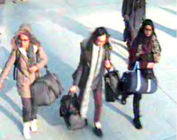 CORRECTING DATE TO MONDAY FEB. 23 - This is a still taken from CCTV issued by the Metropolitan Police in London on Monday Feb. 23, 2015,  of 15-year-old Amira Abase, left,  Kadiza Sultana,16, centre, and Shamima Begum, 15, going through Gatwick airport, south of London, before they caught their flight to Turkey on Tuesday Feb 17, 2015. The three teenage girls left the country in a suspected bid to travel to Syria to join the Islamic State extremist group. (AP Photo/Metropolitan Police) NO ARCHIVE