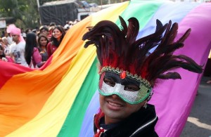 A supporter of the lesbian, gay, bisexual and transgender community wears a feathered mask and participates in a gay pride parade in Mumbai, India, Saturday, Jan. 31, 2015. Gay rights supporters waved flags and danced during the march to celebrate gay pride and to push for the repeal of a colonial-era law that makes homosexuality a crime. (AP Photo/Rajanish Kakade)