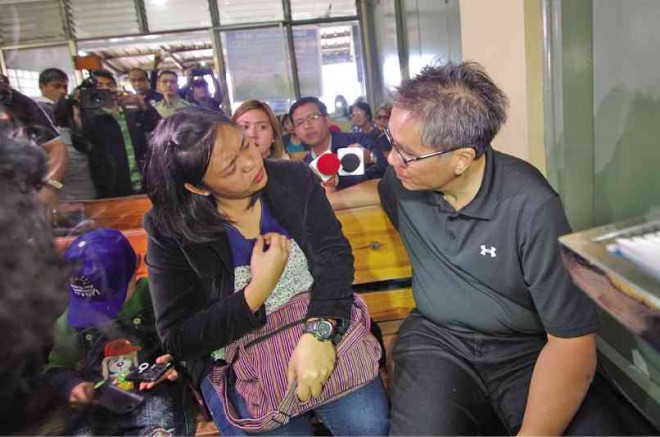 THE MAN who was kept in the dark about “Oplan Wolverine,” Interior Secretary Mar Roxas, condoles with the widow of PO2 Peterson Indongsan Carap, one of the 44 Special Action Force members killed in Mamasapano town, Maguindanao, on Jan. 25. RICHARD BALONGLONG/INQUIRER NORTHERN LUZON