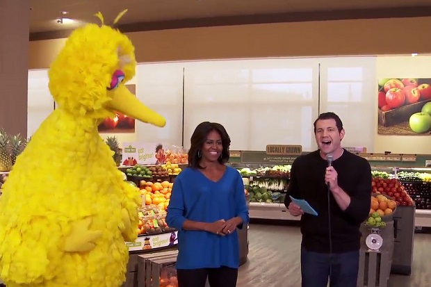 This image from video released by Funny Or Die shows first lady Michelle Obama, center, with Sesame Street character Big Bird, left, and comedian-actor Billy Eichner at a grocery story in Washington to promote healthy eating. (AP Photo/Funny Or Die)