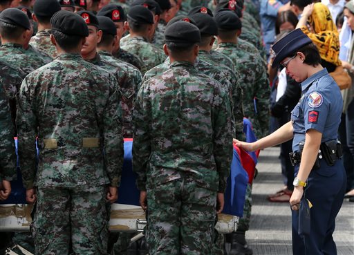 Members of the Philippine National Police Special Action Force mourn the police commandos who were killed in what authorities said was an accidental clash with a Muslim rebel group, Thursday, Jan. 29, 2015 at Villamor Air Base in Pasay, Philippines. AP 