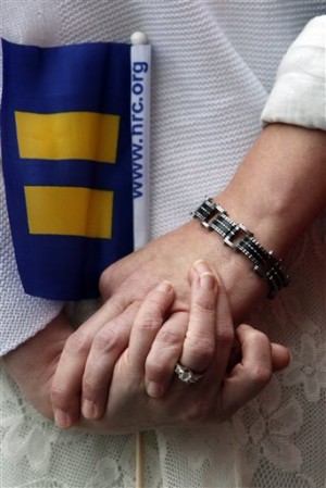 Same-sex couple Dee Bush and Laura Bush hold hands as they wait for the Jefferson County courthouse doors to open so they can be legally married, Monday, Feb. 9, 2015, in Birmingham, Alabama. AP