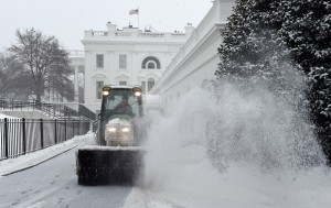 Snow is cleared on the North side of the White House in Washington, Saturday, Feb. 21, 2015. The National Weather Service is calling for 3 to 6 inches of snow and then a trace to a small amount of ice in the area. The cold ground is allowing snow to stick faster, making it difficult for road crews to keep up. (AP Photo/Susan Walsh)