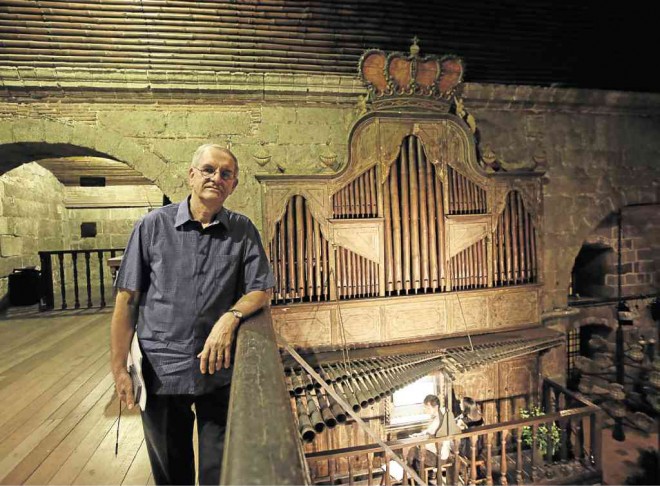 FADING NOTES Leo Renier, executive director of the 40th International Bamboo Organ Festival, stands next to the world-famous instrument inside St. Joseph church, Las Piñas City. AP