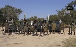 In his file image taken from video released on Oct. 31, 2014, by Boko Haram, Abubakar Shekau, center, the leader of Nigeria's Islamic extremist group. Nigeria and its four bordering countries announced plans Saturday, Feb. 7, 2015, to deploy an 8,750-strong force by next month to combat the growing regional threat posed by Boko Haram.  AP PHOTO/BOKO HARAM 