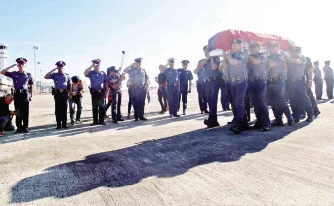 A COFFIN bearing the remains of one of the Fallen 44 SAF men arrive at the Mactan Cebu International Airport, casting a shadow on the airport tarmac and on the continuing effort by the Aquino administration to preserve the gains of the peace process with Moro Islamic Liberation Front. JUNJIE MENDOZA/CEBU DAILY NEWS