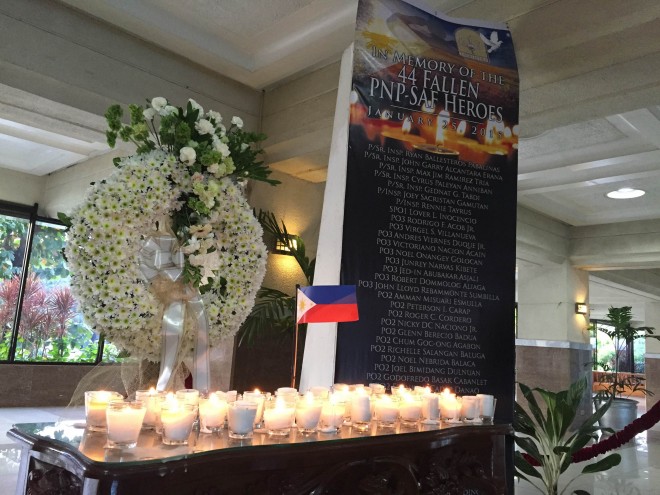 Caption: An altar was set up in the House of Representatives Wednesday for the 44 slain elite cops in the Mamasapano clash. Fourty four candles were lit alongside a flag in the altar. Beside it was a poster bearing the names of the so-called "Fallen SAF 44." Photo by Marc Jayson Cayabyab/INQUIRER.net
