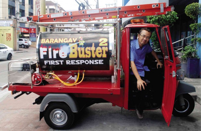 THE ‘MINI’ WITH THE MEANS Antonio Andes Sr. with his Barangay Fire Buster, which he offers as a solution to problems often encountered by fire fighters in congested urban areas. Arnold Almacen