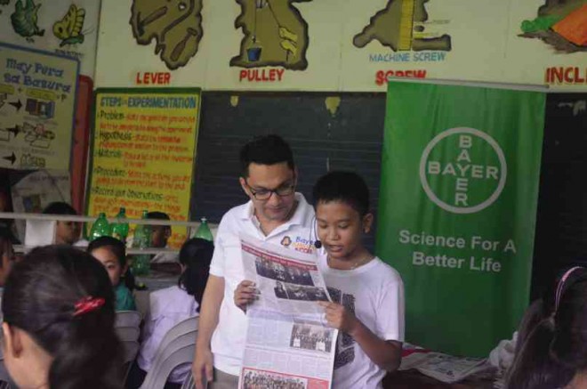 AT CANLUBANG Elementary School, Cutanda (left) guides a newspaper reader