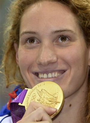 In this Sunday, July 29, 2012 file photo France's Camille Muffat celebrates with her gold medal for the women's 400-meter freestyle swimming final at the Aquatics Centre in the Olympic Park during the 2012 Summer Olympics in London. AP 