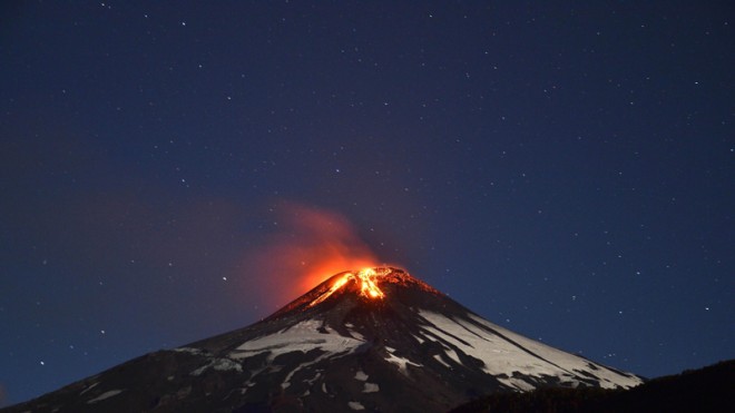 Picture of the Villarrica volcano, located near Villarrica 1200 km from Santiago, in southern Chile, which began erupting on March 3, 2015 forcing the evacuation of some 3,000 people in nearby villages. The Villarrica volcano, one of Chile's most active, began erupting around 3:00 am (0600 GMT), prompting authorities to declare a red alert and cancel classes in schools, the National Emergency Office said.   AFP PHOTO /ARIEL MARINKOVIC