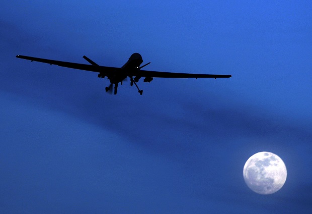 FILE - In this Jan. 31, 2010, file photo, an unmanned U.S. Predator drone flies over Kandahar Air Field, southern Afghanistan on a moonlit night. The Obama administration is amending its regulations for weapons sales to allow the export of armed military drones to friendly nations and allies. The State Department said Tuesday, Feb. 17, 2015, the new policy would allow foreign governments that meet certain requirements  and pledge not to use the unmanned aircraft illegally  to buy the vehicles that have played a critical but controversial role in combating terrorism and are increasingly used for other purposes.  (AP Photo/Kirsty Wigglesworth, File)