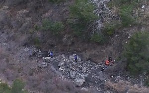 In this image made from TV, rescue workers look amongst debris over the area after a Germanwings Airbus 320 crashed near Seyne-les-Alpes in the French Alps, Tuesday. AP