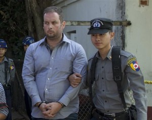 In this Dec. 18, 2014 file photo, a police officer escorts New Zealand citizen Philip Blackwood, left, who is accused of insulting Buddhism, for a court hearing in Yangon, Myanmar. AP