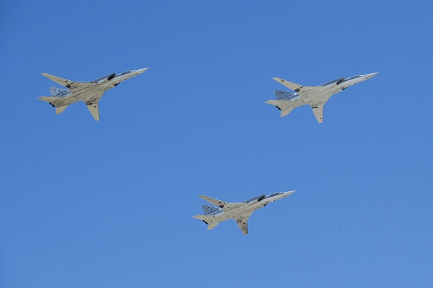 FILE - In this Friday, May 9, 2014 file photo Russian bombers Tu-22M3 fly in formation during a Victory Day Parade, which commemorates the 1945 defeat of Nazi Germany in Moscow, Russia. Russia plans to station state-of-the art missiles to its westernmost Baltic exclave and deploy nuclear-capable bombers to Crimea as part of massive war games intended to showcase the nation's resurgent military power amid bitter tensions with the West over Ukraine. (AP Photo/Pavel Golovkin, File)