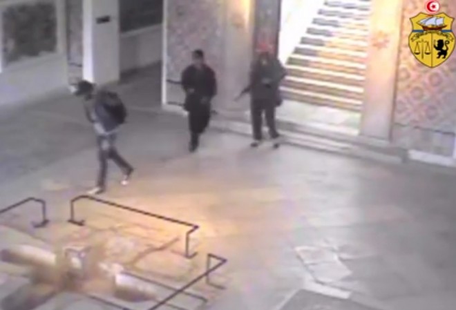 This frame grab from a video released by Tunisia's Interior Ministry shows the gunmen walking through the National Bardo museum during the attack that killed 21 people on Wednesday, March 18, 2015. The one-minute video posted on the ministry's Facebook page Saturday shows the two men walking through the museum, carrying assault rifles and bags. At one point they encounter another man with a backpack walking down a flight of stairs. They briefly acknowledge each other before they walk on in opposite directions. There was no explanation of who the third man was.  AP PHOTO/TUNISIA'S INTERIOR MINISTRY 