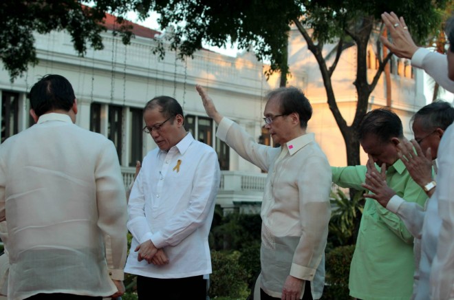 Religious leaders say a prayer for President Benigno Aquino III during a prayer gathering at the Malacañang Monday. Photo by Malacañang Photo Bureau