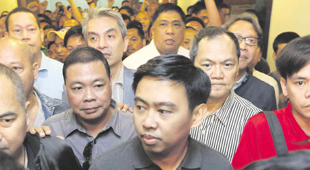 NO GO  Surrounded by supporters, newly suspended Makati City Mayor Jejomar Erwin “Junjun” Binay makes his way to Makati City Hall, where he tells reporters he will continue to hold office until all legal remedies have been exhausted. The Ombudsman has ordered the six-month suspension without pay of Binay and 21 other city officials over alleged irregularities in the P1.2-billion construction of the parking building in Makati.  NIÑO JESUS ORBETA