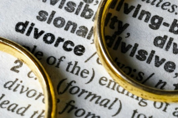 Wedding ring over dictionary open to DIVORCE. STORY: Gabriela hopes to revive divorce bill