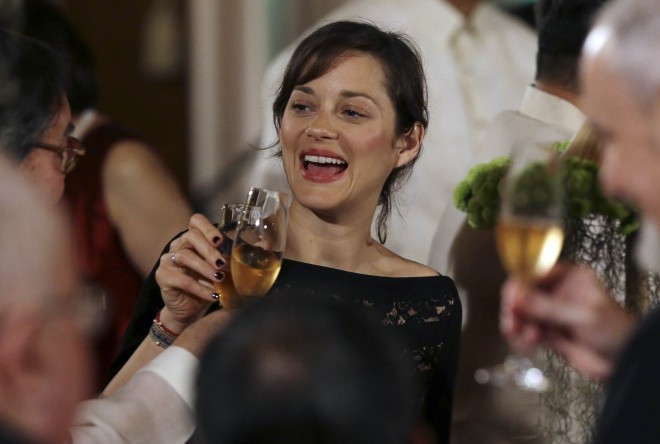 French award-winning actress Marion Cotillard toasts with other guest during a state dinner, at the Malacanang Presidential Palace, in Manila, Philippines, Thursday, Feb. 26, 2015. Cotillard is in the country with French President Francois Hollande on a two-day visit. AP