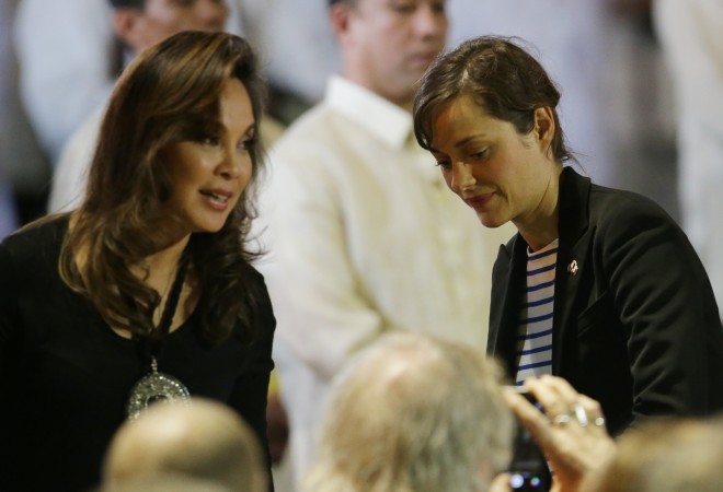 French award-winning actress Marion Cotillard, right, walks beside Philippine Senator Lauren Legarda during the Launch of Manila Call To Action On Climate Change at the Malacanang Presidential Palace, Manila, Philippines on Thursday, Feb. 26, 2015. Cotillard is in the country with French President Francois Hollande for a two-day visit. AP