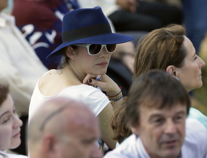 French actress Marion Cotillard watches French President Francois Hollande during his tour of the typhoon-ravaged Guiuan township, in Eastern Samar province in the central Philippines Friday, Feb. 27, 2015. Hollande's two-day state visit focuses on climate change. AP