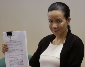 Sen. Grace Poe holds a copy of the Senate probe on the botched Jan.25, 2015, police operation to capture wanted Malaysian Muslim terrorist Zulkifli bin Hir, also known as Marwan, during a news conference Tuesday, March 17, 2015, in Pasay city. The report  found the government peace panel  “suffering from wanton excess of optimism” and said its members “should start speaking for the country and for the government.”   AP FILE PHOTO/BULLIT MARQUEZ