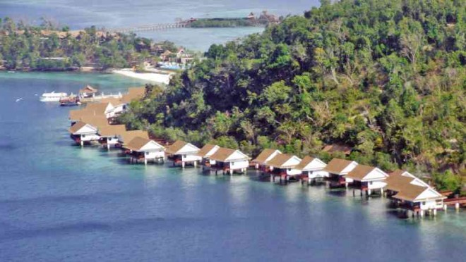 COTTAGES dot the shoreline of Naglayan Island, belonging to Sunlight International which has come under scrutiny for operating a resort in the area without permits. Illegal wood had been found in the resort during a recent raid. REDEMPTO ANDA/ INQUIRER SOUTHERN LUZON 