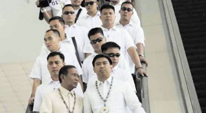 MEN IN BARONG Vice President Jejomar Binay and his son Makati Mayor Junjun Binay arrive with their bodyguards at the SMX Convention Center on Wednesday in Pasay City. JOAN BONDOC